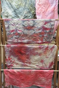 Some of the rinsed fabric drying on a rack